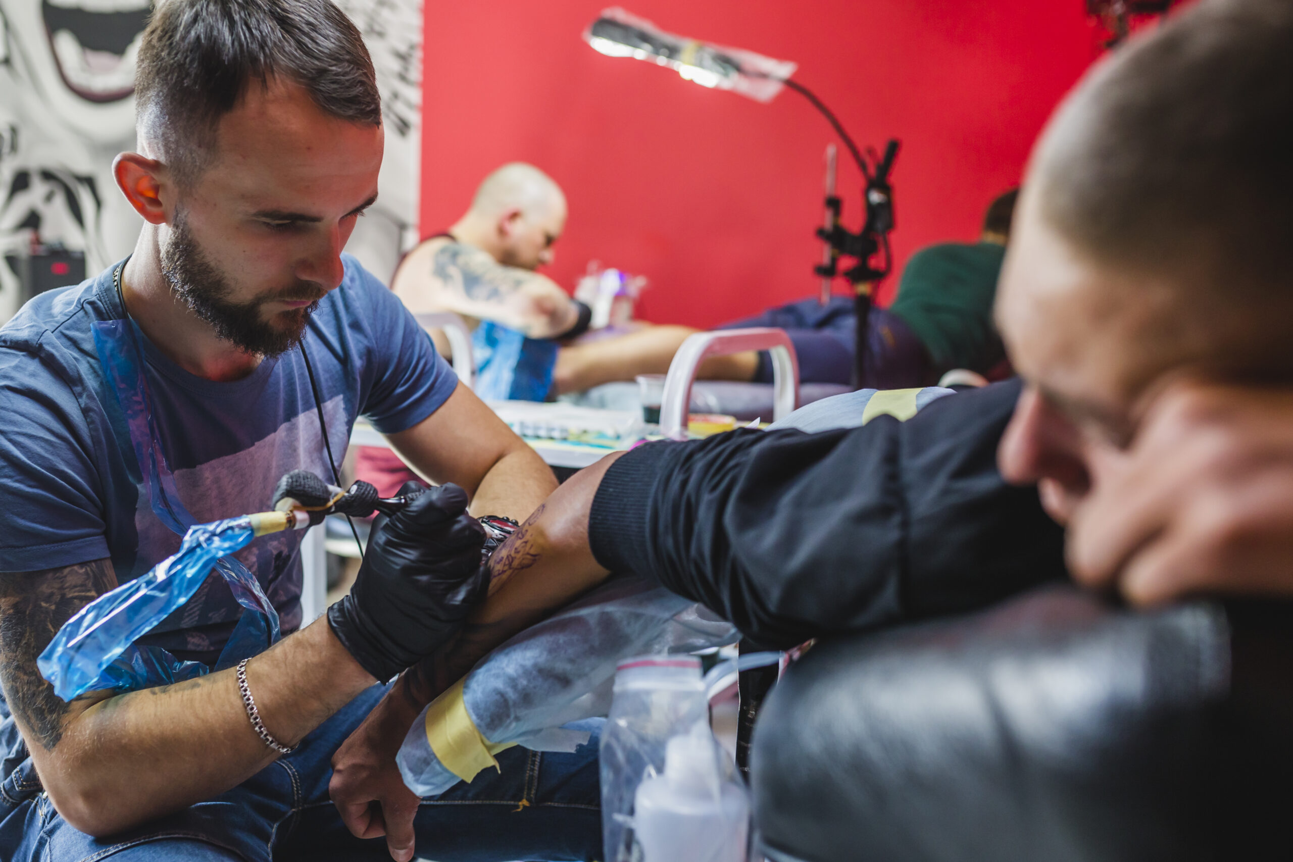 young artist painting tattoo studio scaled